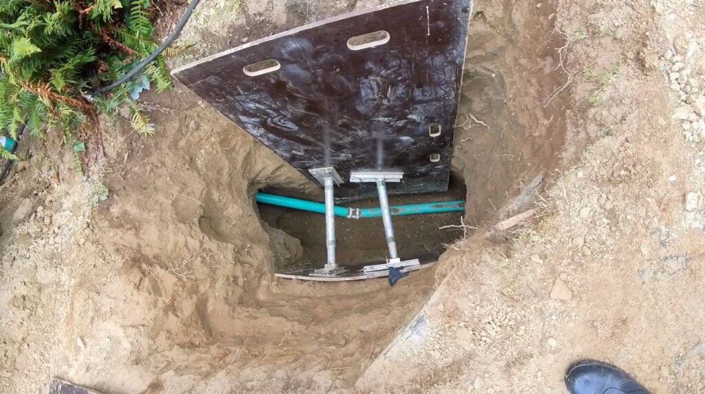 10ft deep main sewer line repair process in Seattle, showing excavation and trenchless pipe lining.