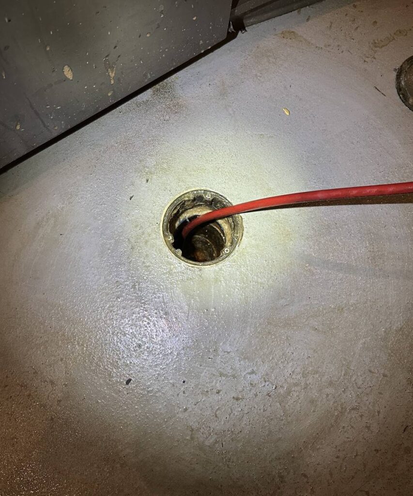 KnightRooter technician using hydro jetting equipment to clean a Seattle home’s drain.