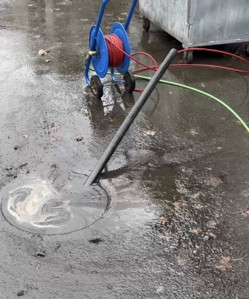Technician performing hydro jetting: KnightRooter technician using hydro jetting equipment to clean a sewer line in Seattle.