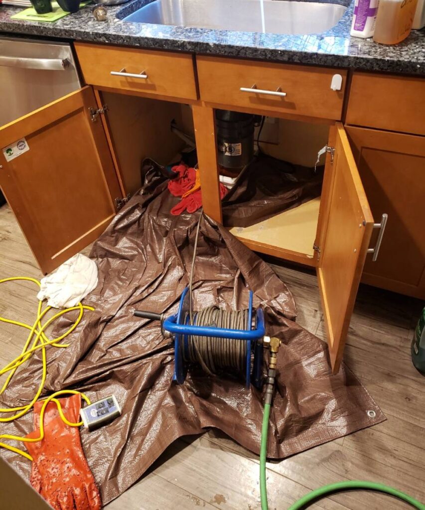 Slow-draining kitchen sink in a Seattle home, signaling the need for professional drain cleaning