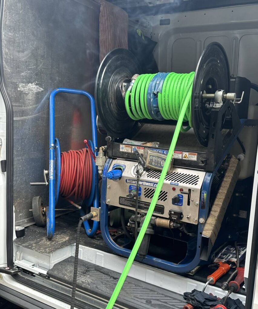 TextCommercial hydro jetting equipment: “High-pressure hydro jetting machine clearing commercial pipes for efficient business plumbing