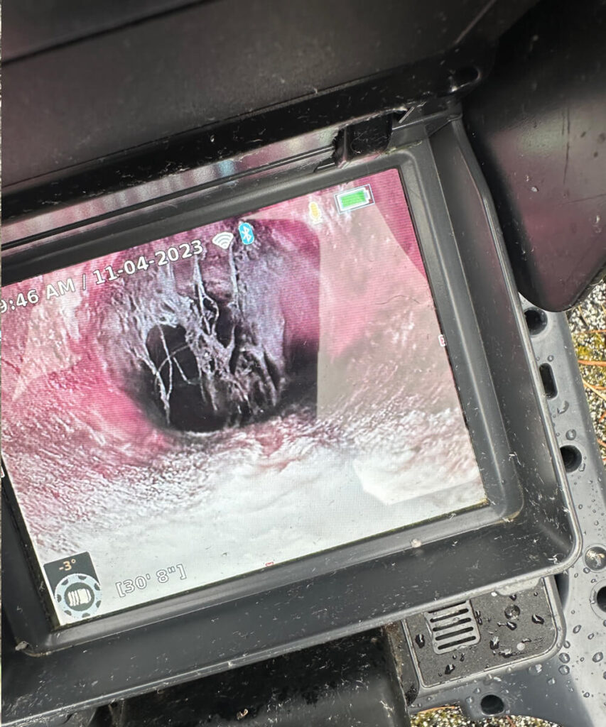 Technician monitoring sewer camera footage: A KnightRooter technician analyzing real-time sewer inspection footage.