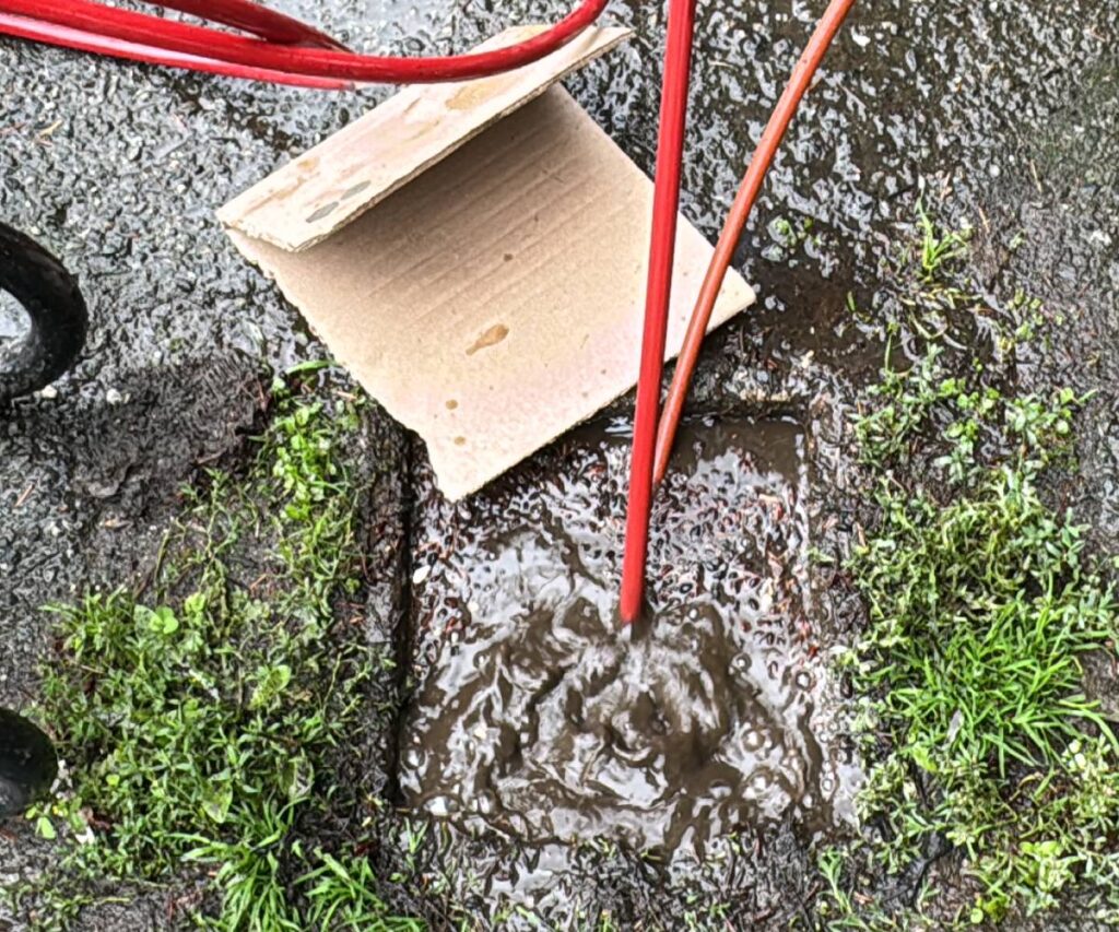 A compact hydro jetting unit clearing a pipe in a remote Seattle property.  
